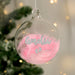 Personalised Baby’s First Christmas Pink Feather Footprints Glass Bauble